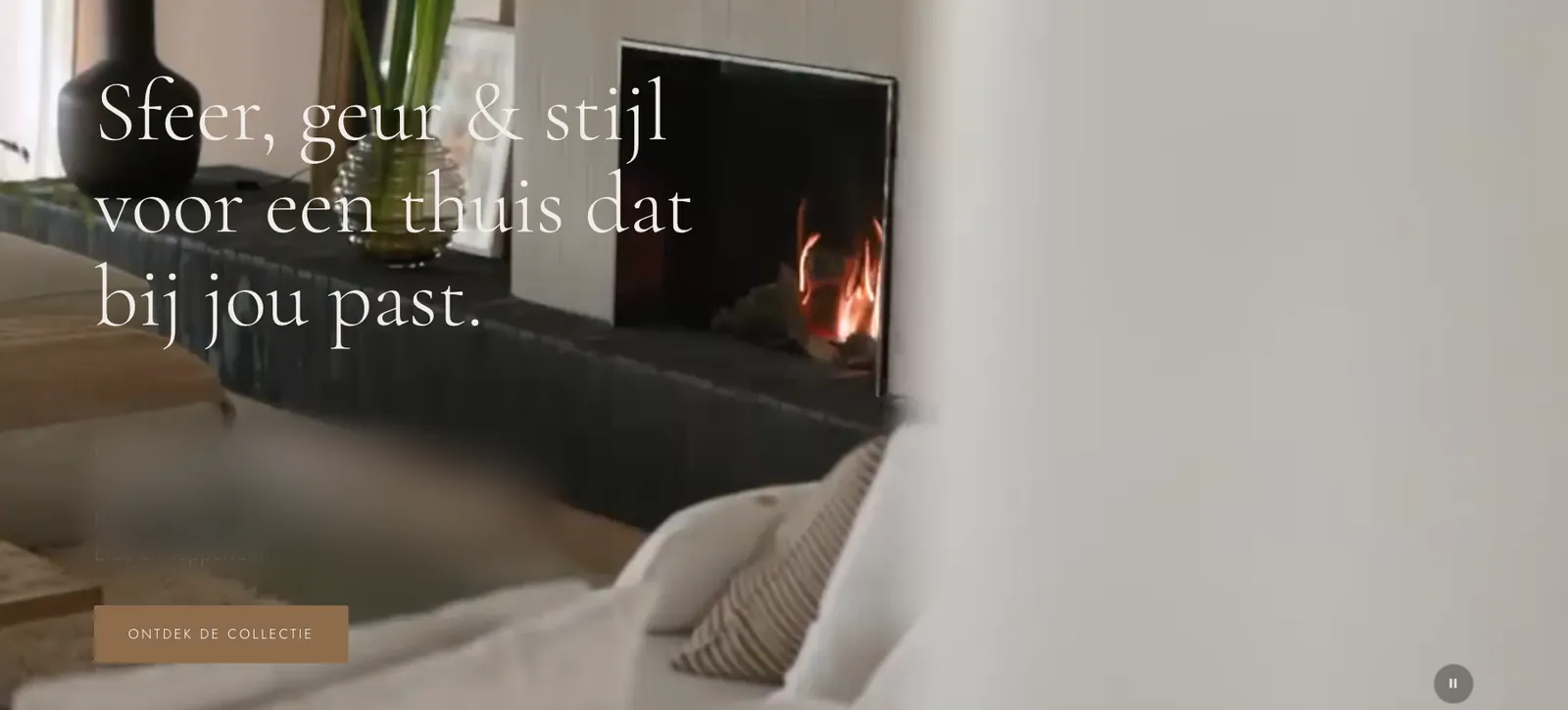 Homepage of a boutique for home fragrance and interior pieces: a warm living room with a fireplace and a serif headline